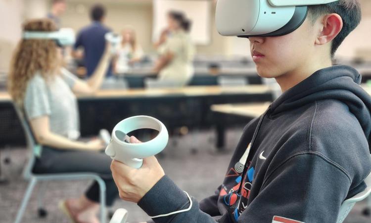 A young male and woman wearing VR headsets.